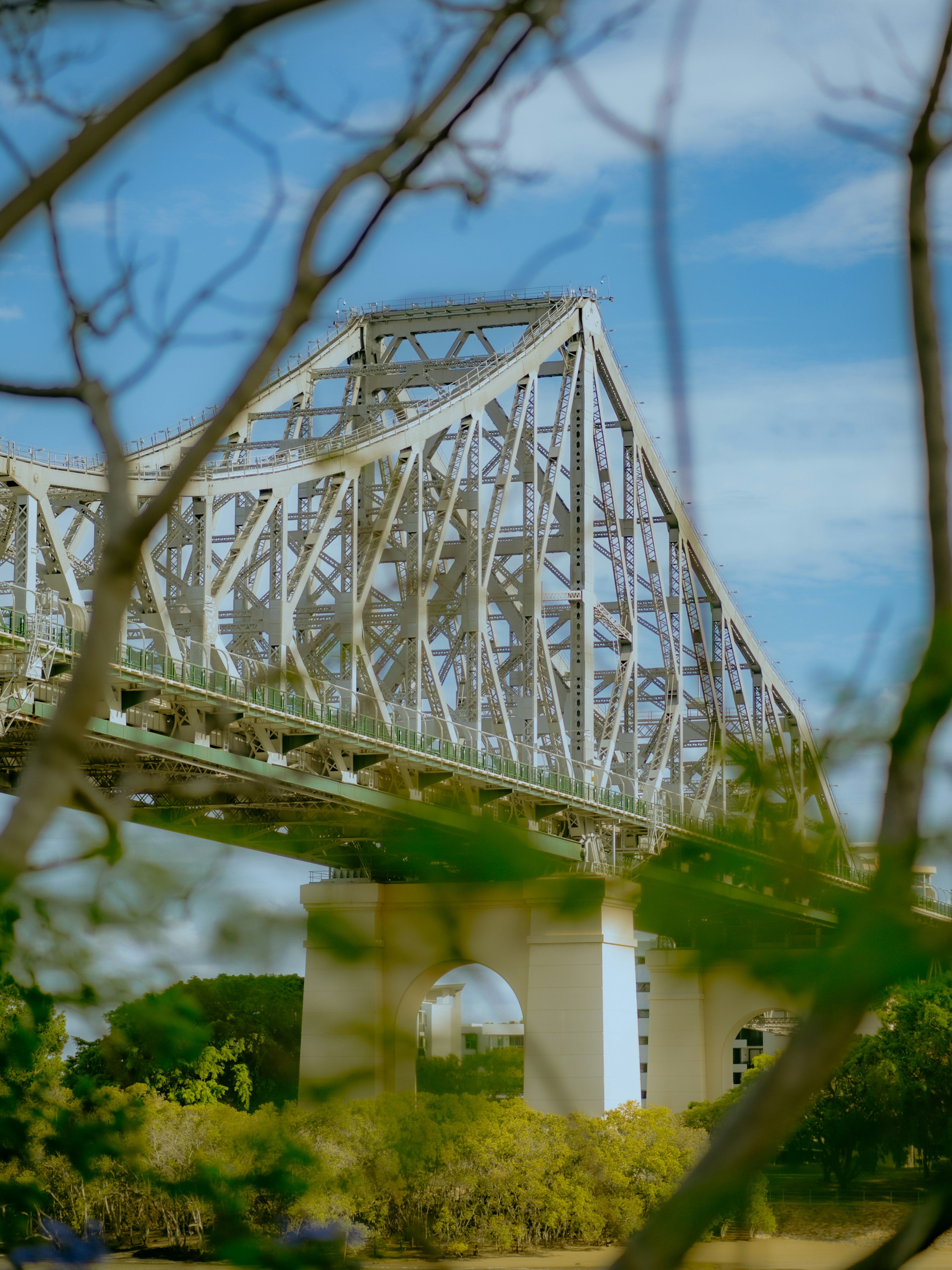 white metal bridge over the river